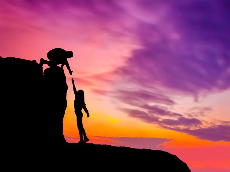 Climber giving a helping hand to other climber